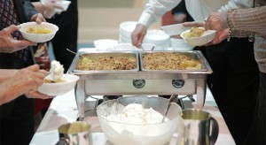 People enjoying food by Chalet Caterers